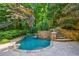 Tranquil pool with stone accents and calming waterfall feature surrounded by lush landscaping at 1255 Beech Haven Ne Rd, Atlanta, GA 30324