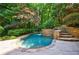 A tranquil backyard pool with a hot tub feature surrounded by mature landscaping and trees at 1255 Beech Haven Ne Rd, Atlanta, GA 30324