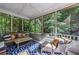 Cozy screened porch with cushioned seating and serene views of the lush backyard at 1255 Beech Haven Ne Rd, Atlanta, GA 30324