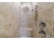 Close-up of a shower with a tiled bench and overhead shower head, with custom stone tile throughout at 1255 Beech Haven Ne Rd, Atlanta, GA 30324