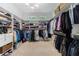 Spacious walk-in closet featuring custom shelving, a chandelier, and multiple racks for clothing storage at 1255 Beech Haven Ne Rd, Atlanta, GA 30324