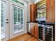Wet bar with custom cabinets, wine refrigerator, granite countertops, and stainless steel sink at 1255 Beech Haven Ne Rd, Atlanta, GA 30324