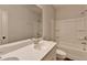 Bright bathroom featuring a shower-tub combo, single vanity, and large mirror at 2505 Whistler Way Ne, Lawrenceville, GA 30043