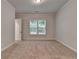 Spacious bedroom with a window and neutral carpet at 2505 Whistler Way Ne, Lawrenceville, GA 30043
