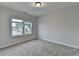 An empty bedroom features neutral walls and carpet, and a window with a view at 2505 Whistler Way Ne, Lawrenceville, GA 30043