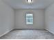Neutral bedroom with carpet and window overlooking green scenery at 2505 Whistler Way Ne, Lawrenceville, GA 30043