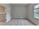 Bright bedroom featuring neutral carpet and a window overlooking green scenery at 2505 Whistler Way Ne, Lawrenceville, GA 30043
