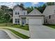 Charming two-story home featuring a manicured lawn and a two-car garage at 2505 Whistler Way Ne, Lawrenceville, GA 30043