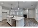 Modern kitchen features a center island with a stainless steel dishwasher and open view to the living room at 2505 Whistler Way Ne, Lawrenceville, GA 30043