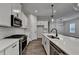 Modern kitchen with white cabinets, stainless steel appliances, and large island at 2505 Whistler Way Ne, Lawrenceville, GA 30043