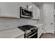 Modern kitchen with white cabinets, stainless steel appliances, and subway tile backsplash at 2505 Whistler Way Ne, Lawrenceville, GA 30043