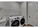 Well-lit laundry room with modern washer and dryer and built in shelving at 2505 Whistler Way Ne, Lawrenceville, GA 30043