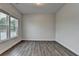 A spacious living room featuring wood floors and plenty of natural light from several windows at 2505 Whistler Way Ne, Lawrenceville, GA 30043