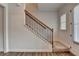 Staircase with carpeted stairs and wood and black railings. View of the front door at 2505 Whistler Way Ne, Lawrenceville, GA 30043