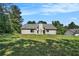Spacious backyard with a well-maintained lawn and siding house on a sunny day at 267 Rocky Point Rd, Covington, GA 30014
