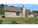 View of the back of the home featuring a large yard, siding, and grey roof at 267 Rocky Point Rd, Covington, GA 30014
