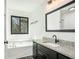 Bathroom with vanity, granite countertop, and soaking tub at 267 Rocky Point Rd, Covington, GA 30014