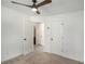 This bright bedroom features a ceiling fan and two closets for storage at 267 Rocky Point Rd, Covington, GA 30014