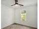 A bright bedroom features a ceiling fan and a window looking out onto a green lawn at 267 Rocky Point Rd, Covington, GA 30014