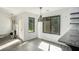 Bright dining area with modern light fixture, windows, and fireplace at 267 Rocky Point Rd, Covington, GA 30014
