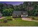 Charming single-story home with a lush green lawn and mature trees in a serene, wooded setting at 267 Rocky Point Rd, Covington, GA 30014