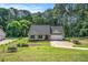 Charming single-story home with a lush green lawn and mature trees in a serene, wooded setting at 267 Rocky Point Rd, Covington, GA 30014