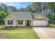 Beautiful home featuring manicured landscaping, a well-maintained lawn, and an attached two-car garage at 267 Rocky Point Rd, Covington, GA 30014