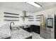 Open kitchen with stainless steel appliances, granite countertops, and subway tile backsplash at 267 Rocky Point Rd, Covington, GA 30014