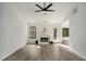 Bright living room featuring vaulted ceiling, fireplace, and modern flooring at 267 Rocky Point Rd, Covington, GA 30014