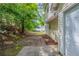 Spacious backyard featuring a stone pathway and lush greenery, leading to a detached garage at 3075 Oakvale Hts, Decatur, GA 30034