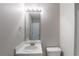 Bathroom with mirror, lighting fixture, sink, vanity and toilet at 3075 Oakvale Hts, Decatur, GA 30034