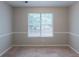 Cozy bedroom featuring neutral-colored walls, a window, and carpeted floor at 3075 Oakvale Hts, Decatur, GA 30034