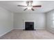 A cozy living room with plush carpeting, a ceiling fan, and a classic fireplace at 3075 Oakvale Hts, Decatur, GA 30034