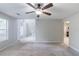 Spacious living room with a ceiling fan, neutral walls, and a view into other areas of the home at 3075 Oakvale Hts, Decatur, GA 30034