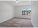 A carpeted bedroom with a large window offering plenty of natural light at 44 Trailview Ln # 78, Hiram, GA 30141
