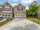 Inviting townhome featuring a brick facade, a two-car garage, and a well-manicured lawn at 44 Trailview Ln # 78, Hiram, GA 30141