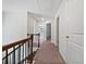 Upstairs hallway with carpet and railing leading to various rooms at 44 Trailview Ln # 78, Hiram, GA 30141