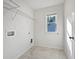 A bright laundry room featuring tile floors and a window for natural light at 44 Trailview Ln # 78, Hiram, GA 30141