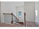 Carpeted staircase with wood railing and black iron balusters leading to the upper level at 44 Trailview Ln # 78, Hiram, GA 30141