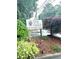 Entrance to the Oaks of Dunwoody community with well-maintained landscaping at 104 Abingdon Way, Atlanta, GA 30328