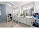Well-lit bathroom featuring a long double vanity, mirrored closet, and gray walls at 104 Abingdon Way, Sandy Springs, GA 30328