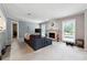 Bright living room with fireplace, large window, and a comfortable gray sofa at 104 Abingdon Way, Sandy Springs, GA 30328