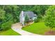 Aerial view of home showcasing a lush, tree-lined property with driveway and manicured lawn at 138 Hartwood Dr, Woodstock, GA 30189