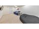 Spacious basement featuring a comfortable seating area with a sofa, beanbag chair, and neutral carpeting at 138 Hartwood Dr, Woodstock, GA 30189