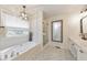 Bright bathroom with a soaking tub, glass-enclosed shower, and stylish modern finishes at 138 Hartwood Dr, Woodstock, GA 30189