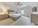 Comfortable bedroom with neutral walls, carpet, a ceiling fan, and a television at 138 Hartwood Dr, Woodstock, GA 30189