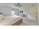 Bright bedroom featuring neutral walls, carpet, a ceiling fan, and a television at 138 Hartwood Dr, Woodstock, GA 30189