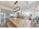 Dining area with modern lighting, stainless appliances, and access to the living room at 138 Hartwood Dr, Woodstock, GA 30189