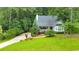 View of the front of the house with well-manicured landscaping and a cozy front porch at 138 Hartwood Dr, Woodstock, GA 30189