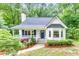 Charming home featuring a landscaped front yard, inviting porch, and classic architectural details at 138 Hartwood Dr, Woodstock, GA 30189